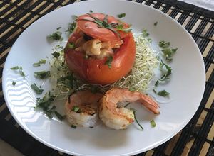 Una foto de Tomate relleno con camarones al ajillo