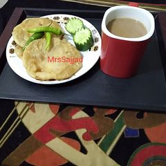A picture of Daal Kachori With tea.