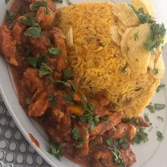 A picture of Mexican rice with Mexican Chicken.