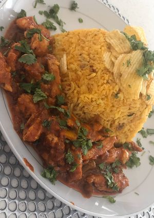 A picture of Mexican rice with Mexican Chicken.