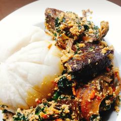 A picture of Egusi soup with fufu.