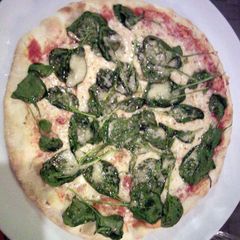 A picture of Spinach and cheese pizza.