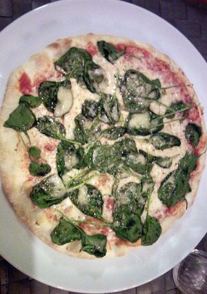 A picture of Spinach and cheese pizza.
