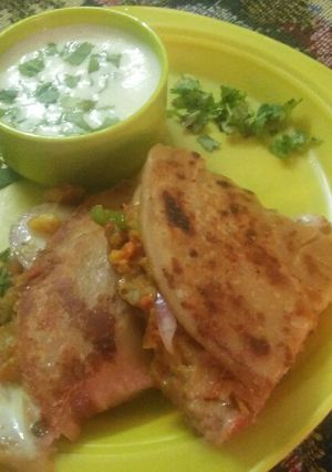 A picture of Veg seekh kabab Paratha with cheesy dip.