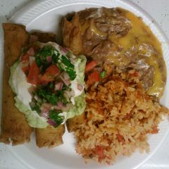 A picture of Rolled tacos with refried beans and Spanish rice.