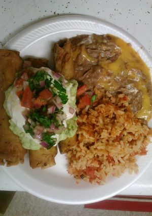 A picture of Rolled tacos with refried beans and Spanish rice.