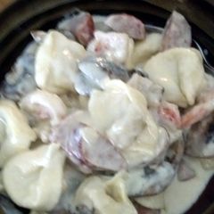 A picture of Fettucine alfredo w/shrimp, andouille sausage, and mushrooms.