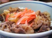 A picture of thin sliced beef with rice