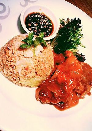 A picture of Oriental fried rice wth chicken.