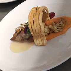 A picture of Bourbon chicken breast /cherry glaze /veloute sauce / puff pastry lattice.