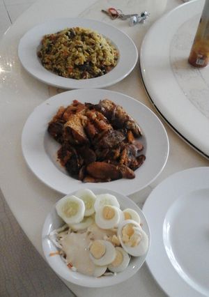A picture of Seafood Fried Rice with baked plantain and creamy coleslaw.
