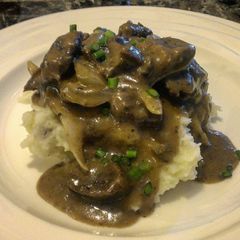 A picture of Beef Tips with Onion & Mushroom Gravy.
