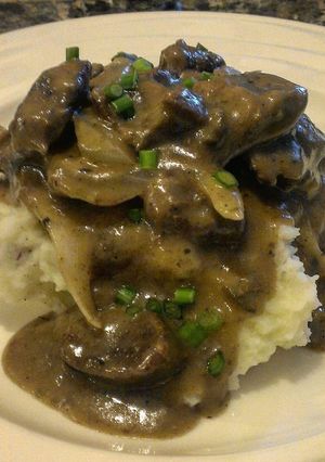 A picture of Beef Tips with Onion & Mushroom Gravy.