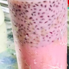 A picture of A glass of milk with basil seeds.