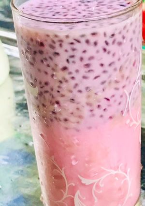 A picture of A glass of milk with basil seeds.