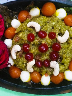 A picture of Sizzling dudhi halwa with mini gulab jamun and rasgulla.
