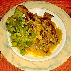 A picture of Whole chicken legs with curry onions..