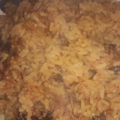 A picture of Jellof rice with dry fish.