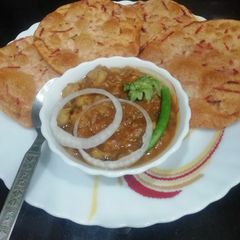 A picture of Beetroot puri with white chana.