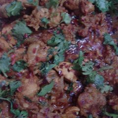 A picture of Indian spicy chicken with potato.
