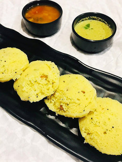 A picture of Sambhar and Rawa Idli with Coconut Chutney.