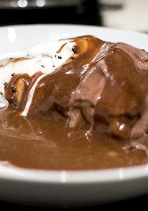 A picture of Hot chocolate Mars sauce with ice -cream.