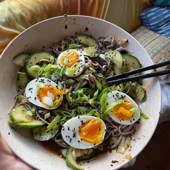A picture of Smashed cucumber cold noodle salad with soft boiled eggs.