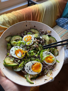 A picture of Smashed cucumber cold noodle salad with soft boiled eggs.