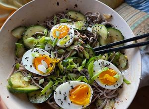 A picture of Smashed cucumber cold noodle salad with soft boiled eggs.