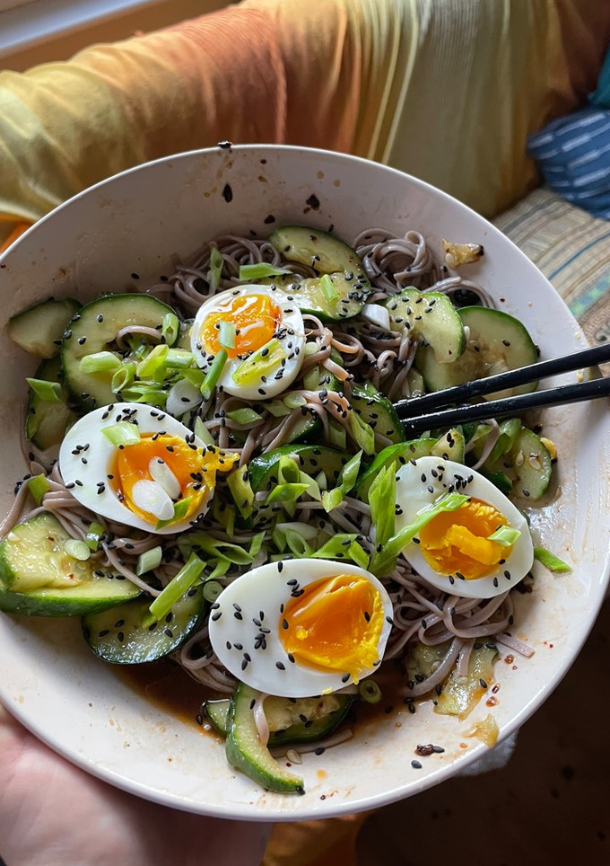 A picture of Smashed cucumber cold noodle salad with soft boiled eggs.