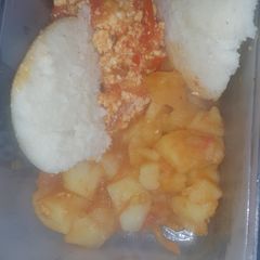 A picture of Scrambled eggs served with waru and ugali.