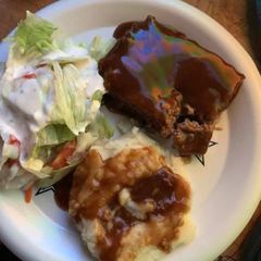 A picture of Sautéed Onion MeatLoaf With mashed potatoes and salad.