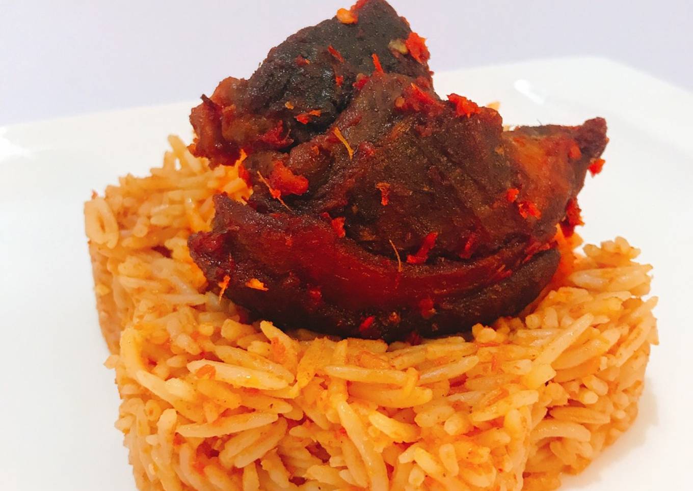 Jollof rice and fried goat peppered goat meat
