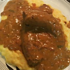 A picture of Sausage With Brown Onion Gravy..