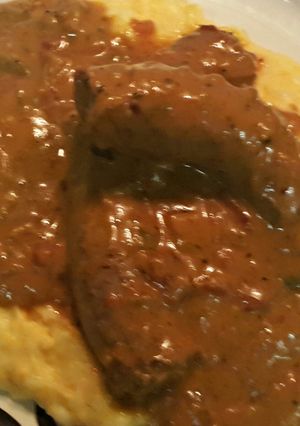 A picture of Sausage With Brown Onion Gravy..