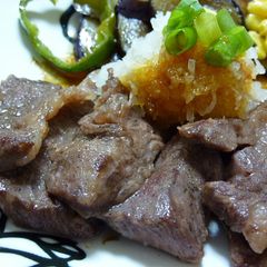A picture of Grated Garlic and Soy Sauce over Beef Steak.
