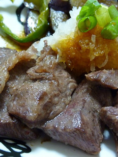 A picture of Grated Garlic and Soy Sauce over Beef Steak.