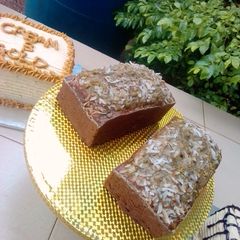 A picture of Banana loaf with coconut topping.