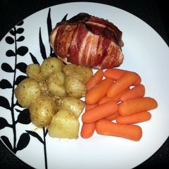 A picture of Bacon wrapped, stuffed Chicken Breast.
