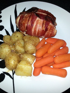 A picture of Bacon wrapped, stuffed Chicken Breast.