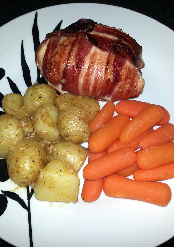 A picture of Bacon wrapped, stuffed Chicken Breast.
