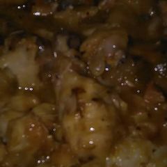 A picture of Chicken with rice & gravy.