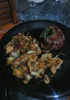 A picture of Stuffed Pinwheel and fried cabbage.