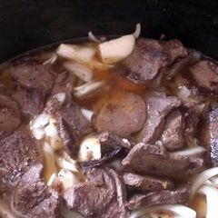 A picture of Deer steak With potatoes onions carrots.