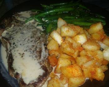 Easy Prepare Recipe New York Steak with roasted garlic cream sauce yucca root and stir fried green beans Very Delicious