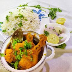 A picture of Chicken Curry with Jeera Rice.