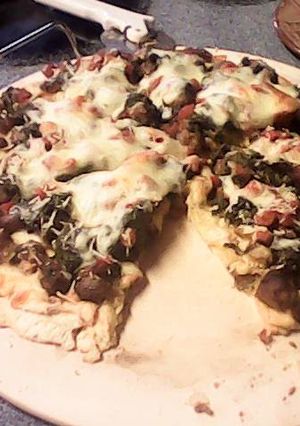 A picture of Italian Sausage Spinach Ricotta Cheese Pizza.