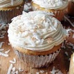 A picture of COCONUT CUPCAKES WITH WHITE CHOCOLATE BUTTERCREAM.