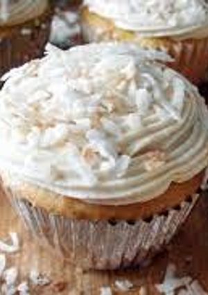 A picture of COCONUT CUPCAKES WITH WHITE CHOCOLATE BUTTERCREAM.