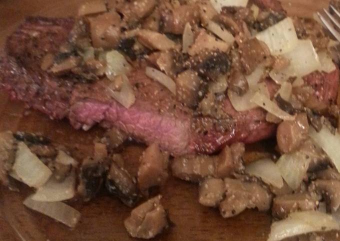 Grilled steak with sauteed mushrooms and onions